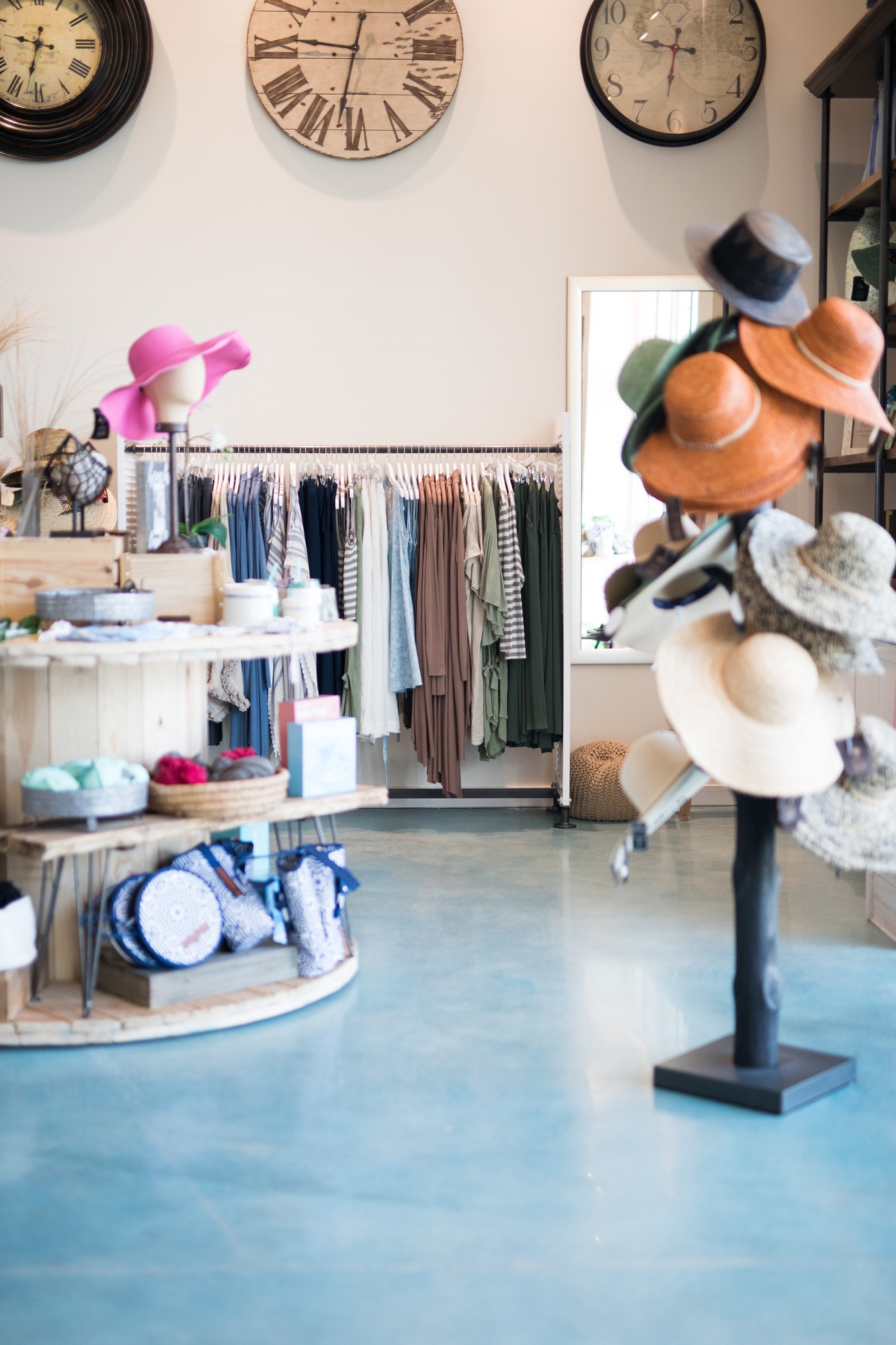 Interior of clothing store shop vintage clothes, hats and homewares clocks
